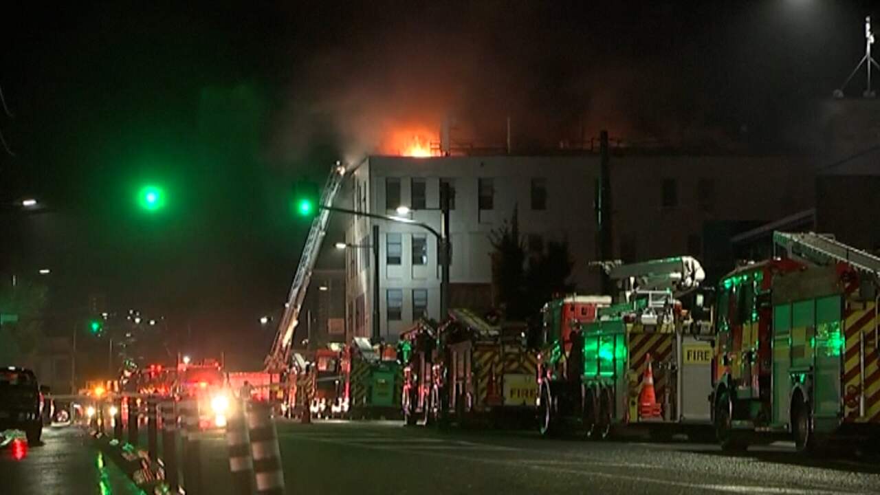 Image from video: Firefighters extinguish deadly fire in New Zealand hostel