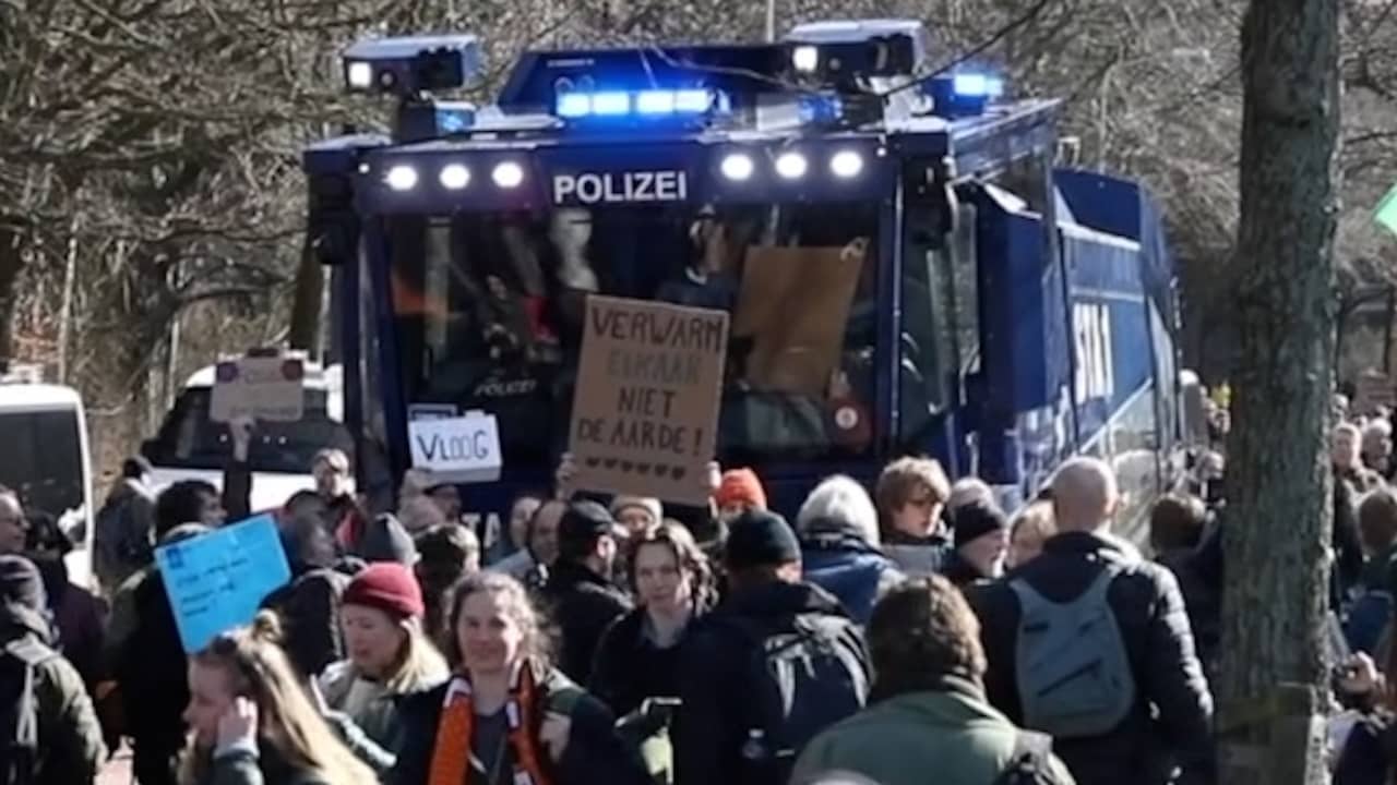 Image from video: Extinction Rebellion activists block water cannon