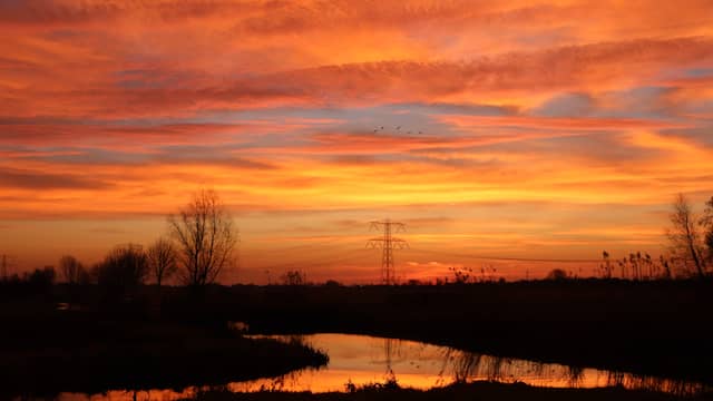 Martha Reumermann stond vroeg op in de omgeving van Gouda. De lucht kleurt oranje en rood doordat het stof de lichtbaan van de zon breekt en veel licht tegenhoudt. Het rode licht is echter niet gevoelig voor het Saharastof en schijnt fel door, wat leidt tot extra rode zonsondergangen en -opkomsten.