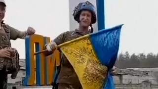Oekraïense soldaat zwaait met nationale vlag na verovering Lyman