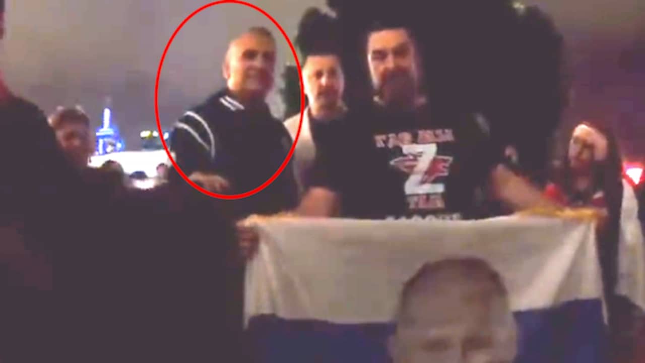Image from video: Djokovic's father poses with Putin supporters at Australian Open