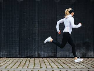 Vrouw is aan het hardlopen in de stad