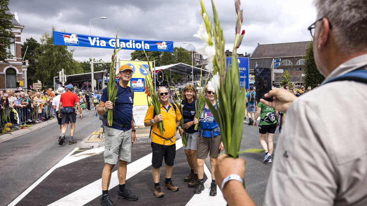 Hikers are photographed on Via Gladiola, the end point of this year's three-day Four Days Marches.  Due to the heat, the first walking day on Tuesday was canceled.