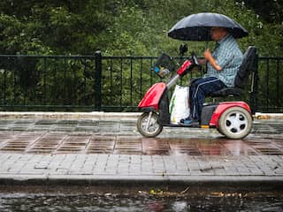 Man in scootmobiel trotseert de regen