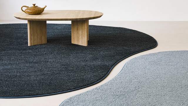 Opdelen van de ruimtes met verschillende kleuren tapijt.