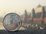A Russian ruble coin is pictured in front of the Kremlin in central Moscow, on November 20, 2014. After having recently spent billions of dollars per day to support the ruble in a flexible trading band that limited swings in the currency, the Bank of Russia ended its unlimited daily interventions to avoid speculation against the currency. Russian ruble has lost more than 30 percent during the last four months to Euro and US dollar. AFP PHOTO / ALEXANDER NEMENOV