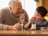 Opa en kleinzoon eten koekjes en melk