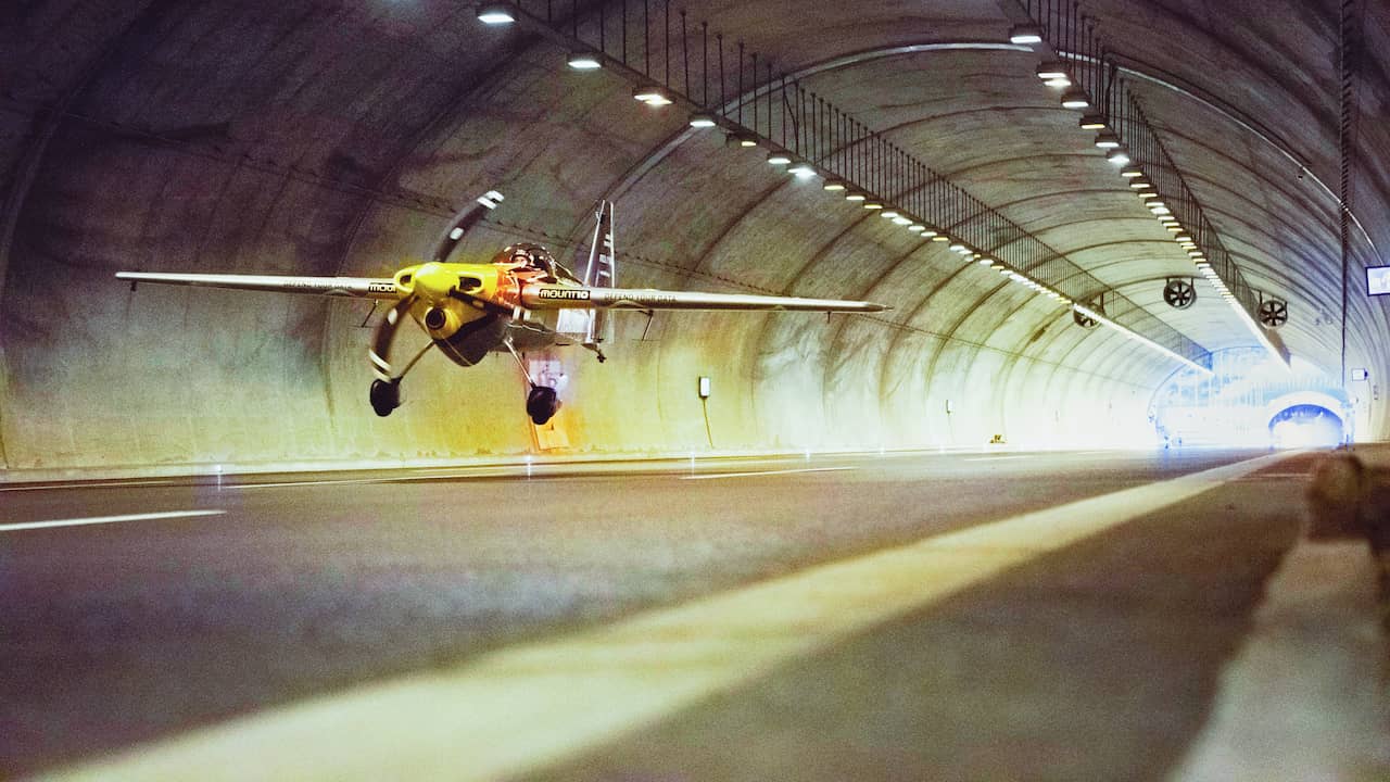 Beeld uit video: Stuntpiloot vliegt als eerste met vliegtuig door twee tunnels