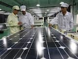 CHINA, Huaibei : Chinese workers inspect a solar panel at the Tianxiang Solar Energy Equipment Factory in Huaibei, east China's Anhui province on March 21, 2012. China sought to defuse a trade row with the US after the latter imposed duties on Chinese solar products, saying it would not hurt ties, even as state media cried protectionism. CHINA OUT AFP PHOTO