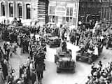 Toeschouwers juichen en zwaaien naar de geallieerden tijdens de intocht van de bevrijding van Nederland. 