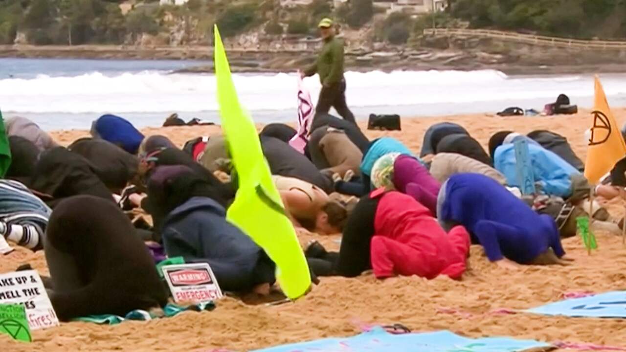 Klimaatactivisten steken 'kop in het zand' in Sydney