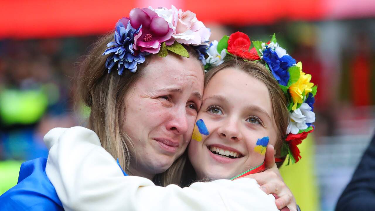 A Ukrainian supporter is comforted after her country misses the World Cup.