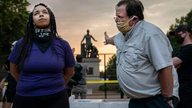 A woman and man argue over a controversial statue of former US President Abraham Lincoln in Lincoln Park in Washington.