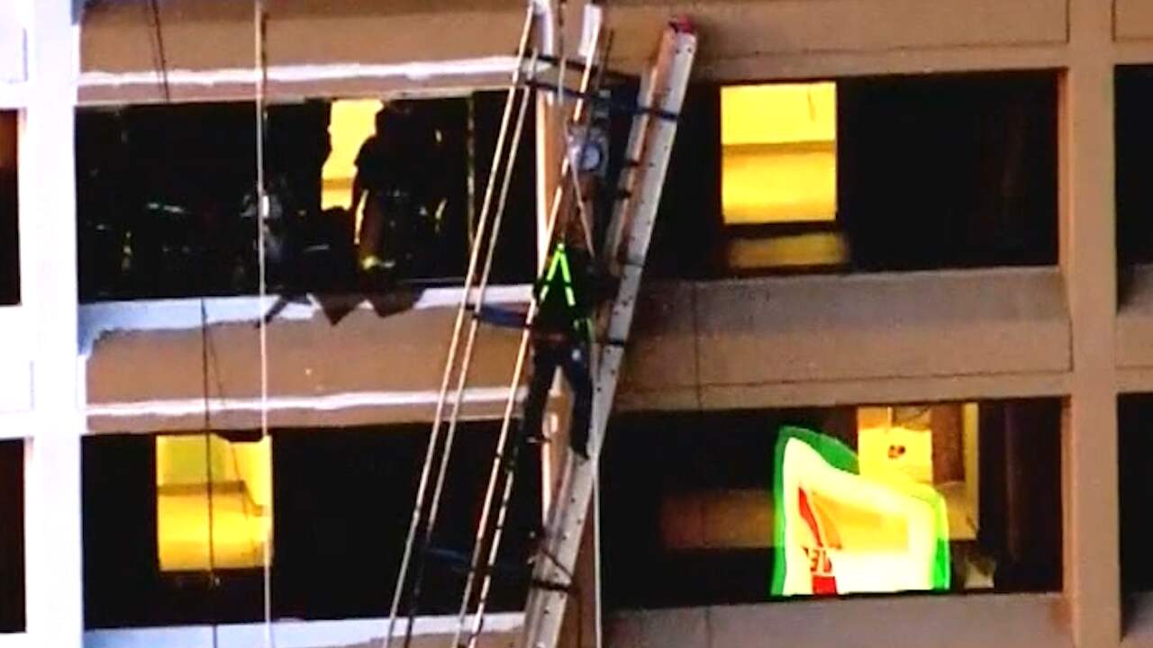 American Painters Hang On Building After Collapsing Building
