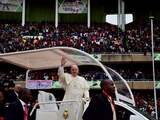 Pope Francis waves from his "Popemobile" as he arrives at the Kasarani Stadium in Nairobi on November 27, 2015 for a meeting with youths. Pope Francis lashed out at wealthy minorities who hoard resources at the expense of the poor as he visited a crowded slum in the Kenyan capital. "These are wounds inflicted by minorities who cling to power and wealth, who selfishly squander while a growing majority is forced to flee to abandoned, filthy and run-down peripheries," the 78-year-old pontiff told crowds in the Nairobi shanty town of Kangemi. AFP PHOTO / GIUSEPPE CACACE